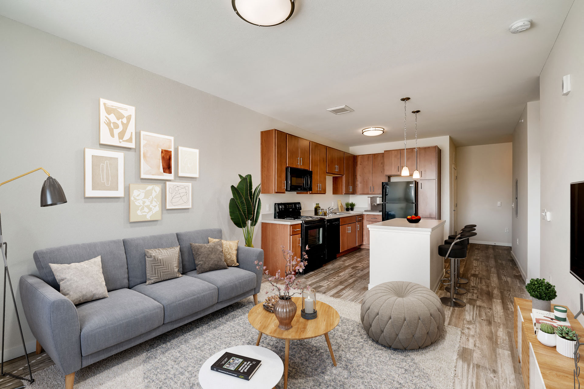 a living room and kitchen with a couch and a table