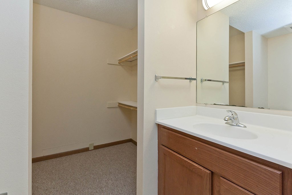 an empty bathroom with a sink and a mirror