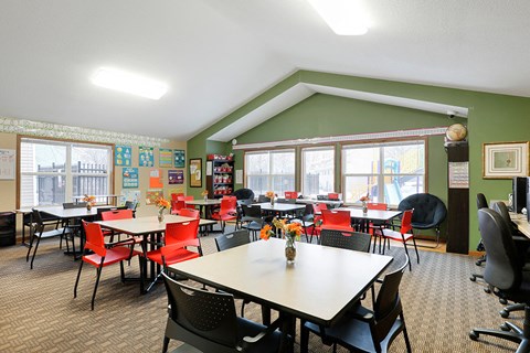 a dining room with tables and chairs and windows
