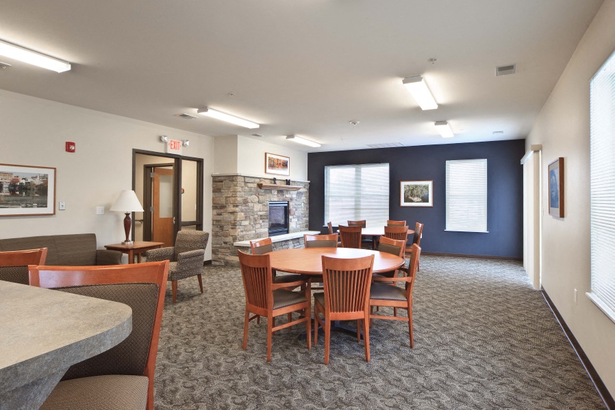 a conference room with a table and chairs and a fireplace