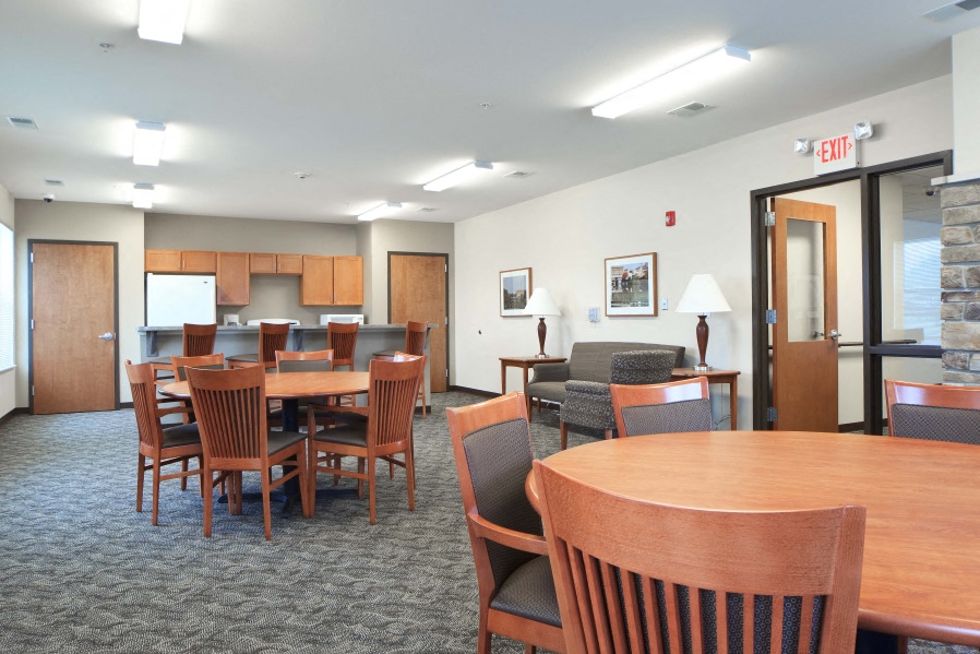 a dining room and living room with tables and chairs