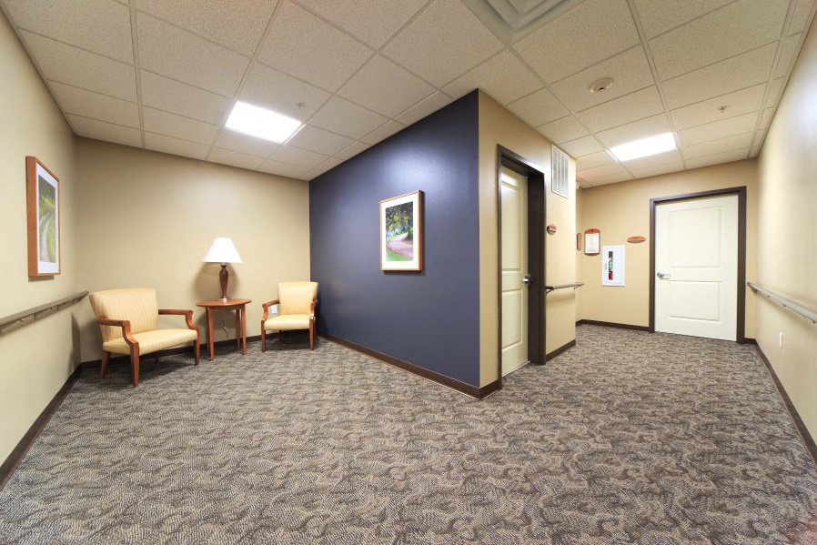 a room with a blue wall and chairs and a door