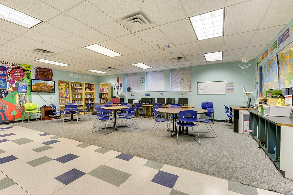a classroom at a school with tables and chairs