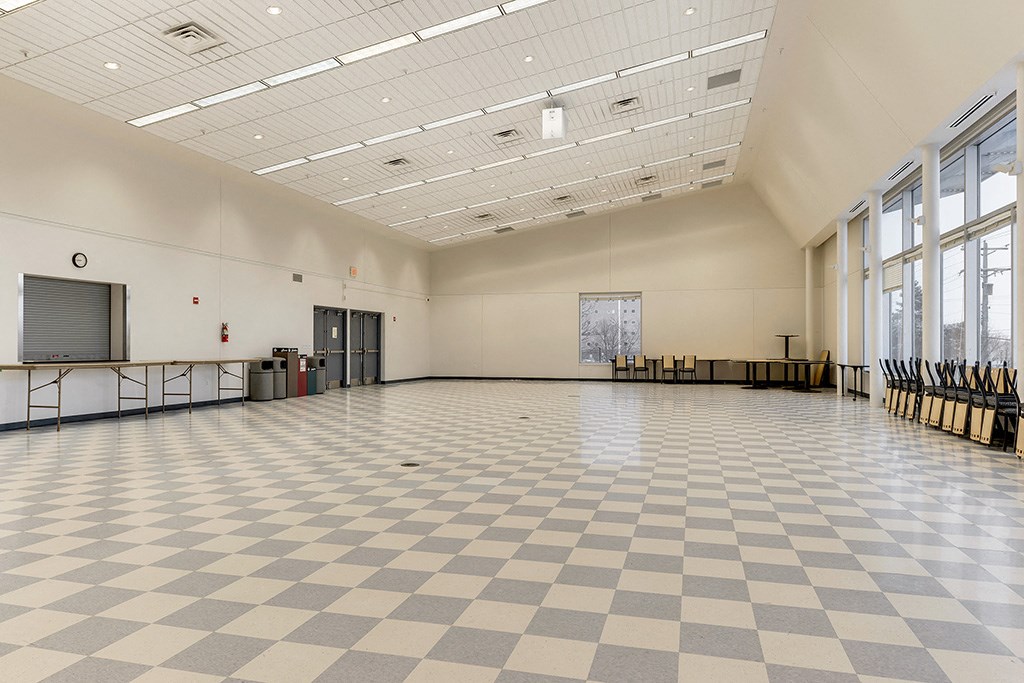 a large room with a checkered floor and large windows