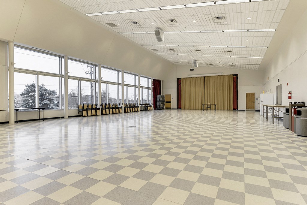a large room with a checkered floor and large windows