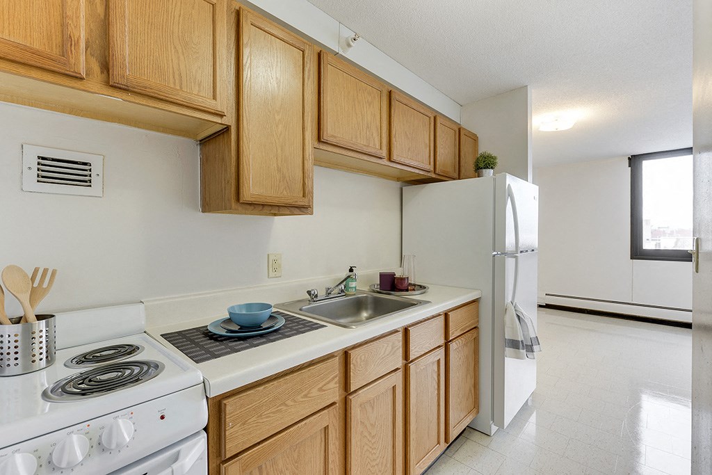 a kitchen with a stove sink and refrigerator