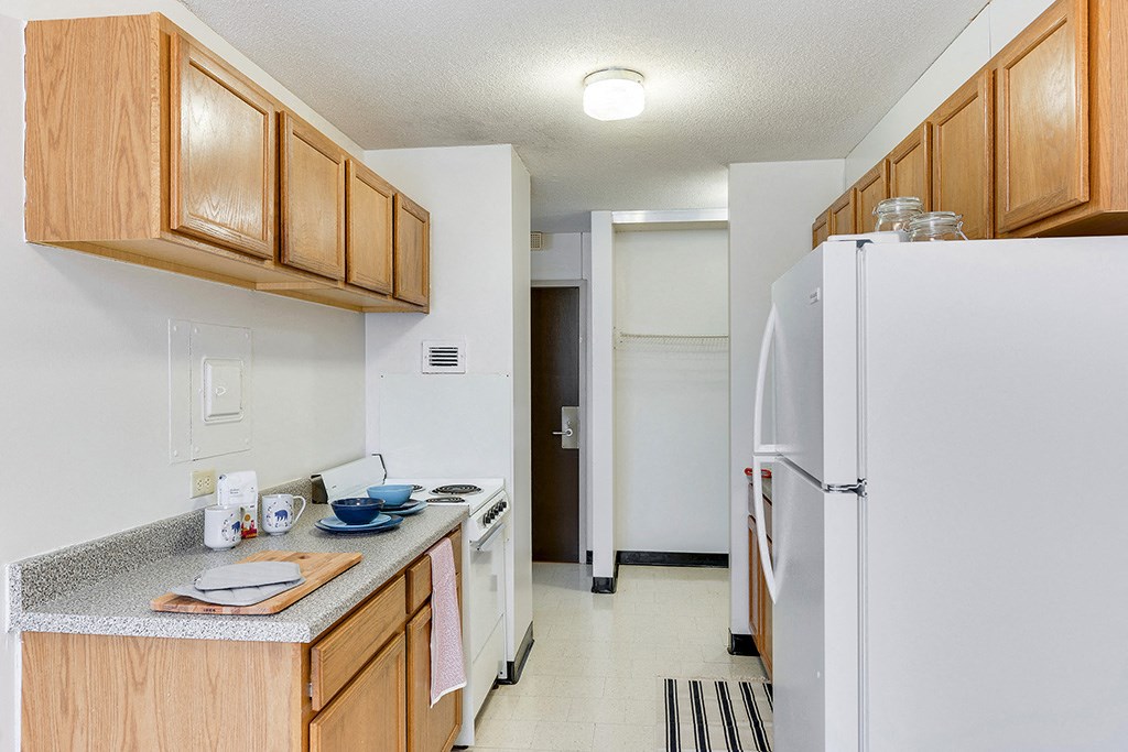 a kitchen with a refrigerator and a sink