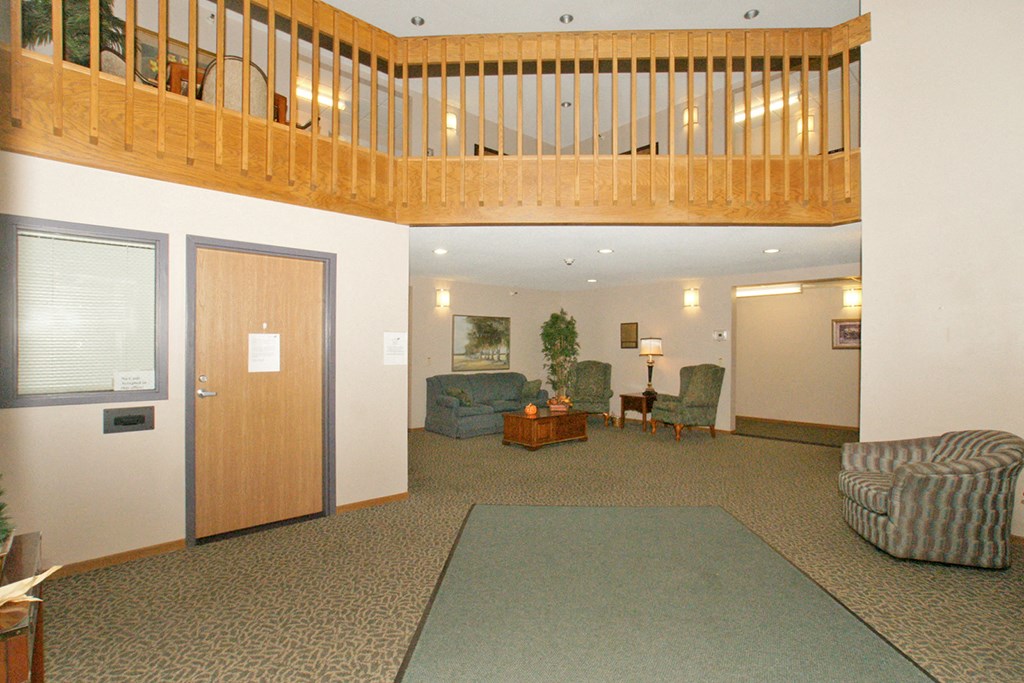 an empty living room with a staircase in the ceiling