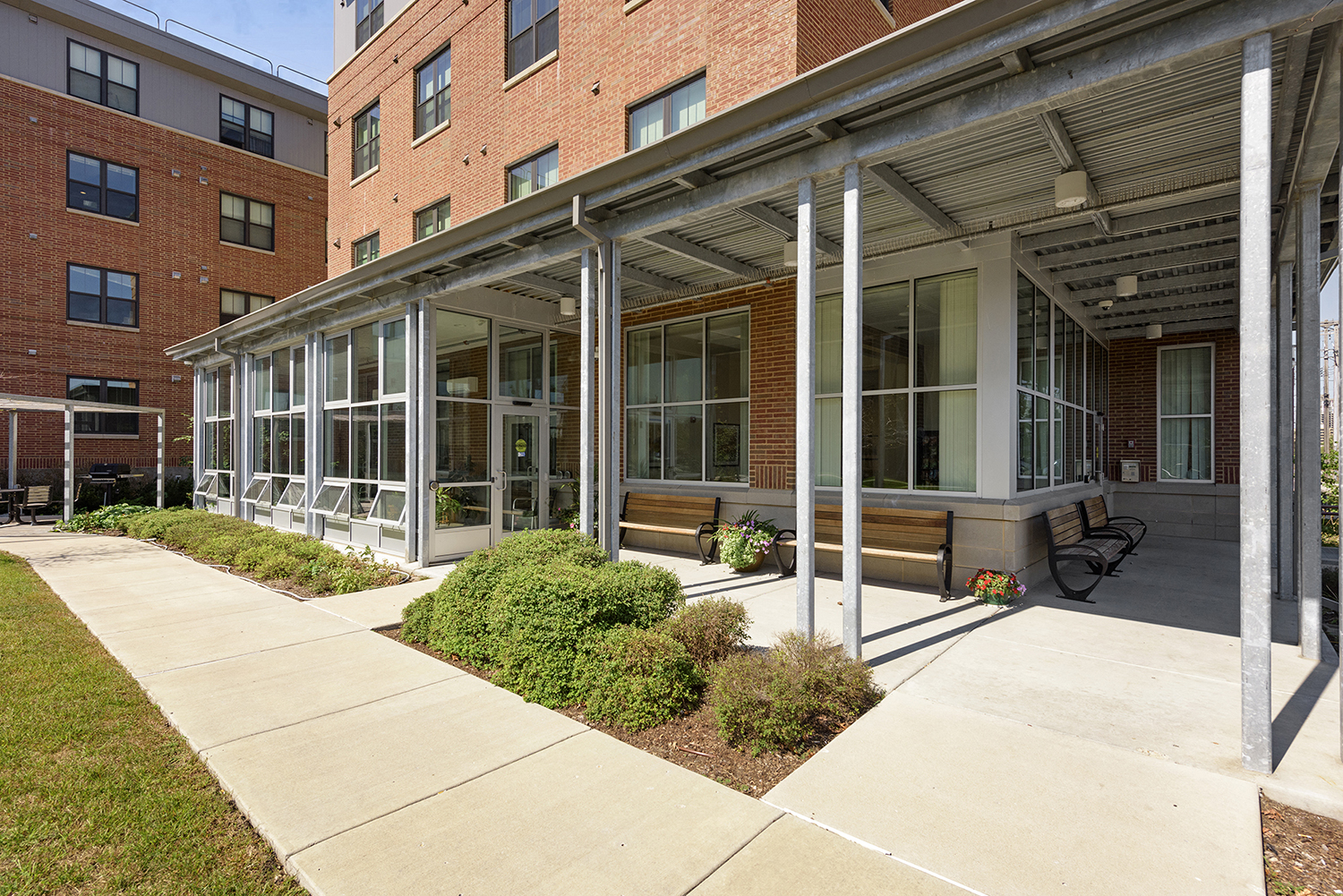 the courtyard of a building with a sidewalk and benches