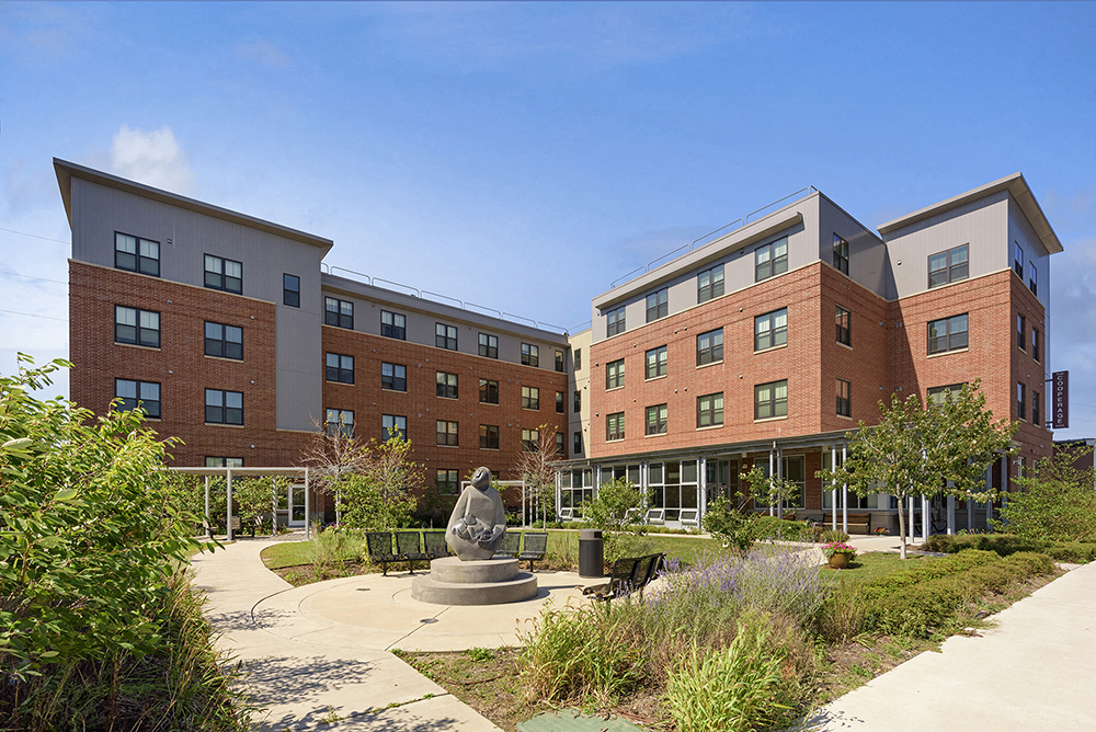 a courtyard in front of a building with a statue
