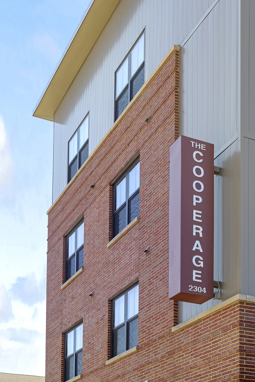 a brick building with a sign that reads the cooper agency