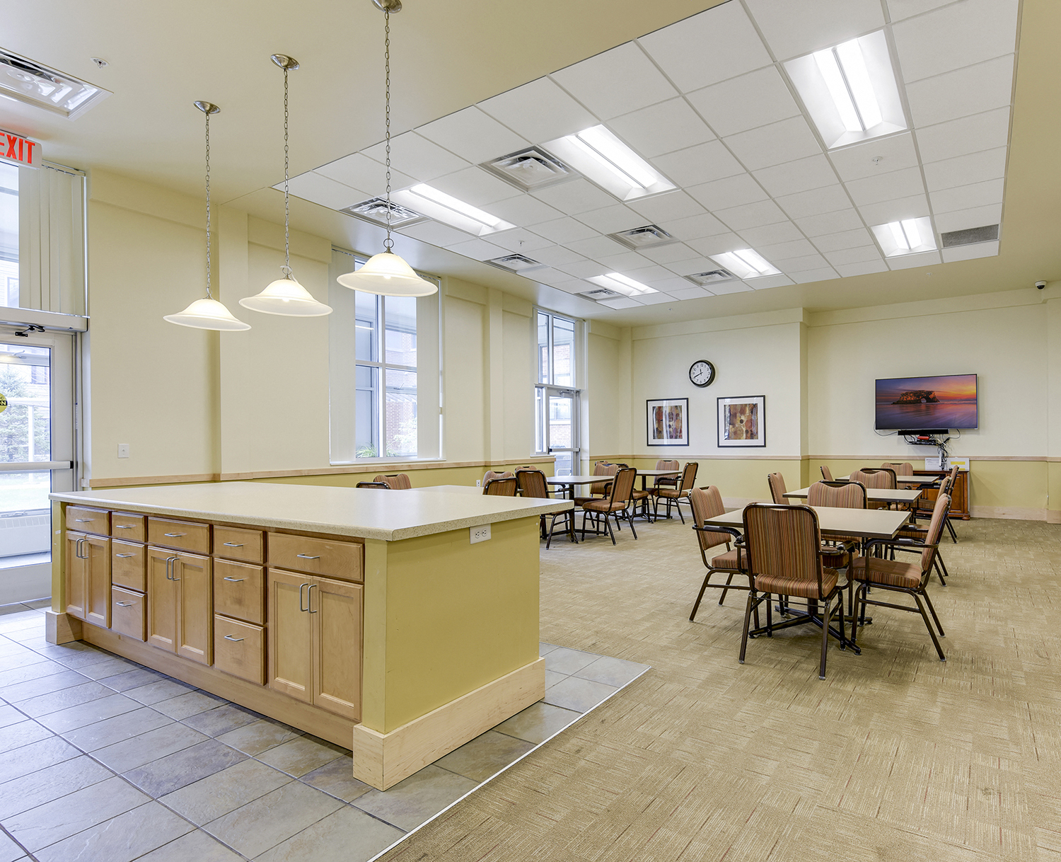 a multipurpose room with tables and chairs and an island in the middle