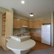 a kitchen with a white island and a refrigerator
