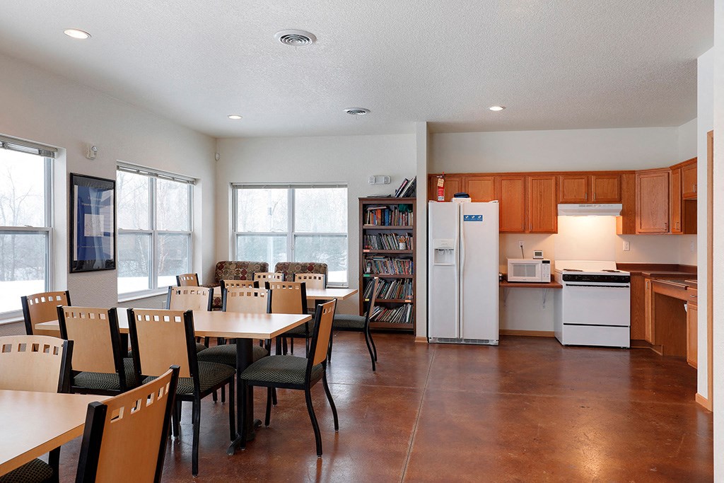 a kitchen and dining room with a table and chairs