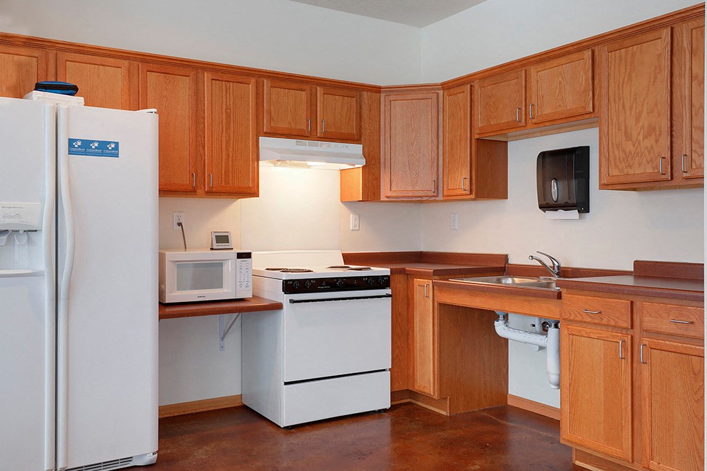a kitchen with white appliances and wooden cabinets