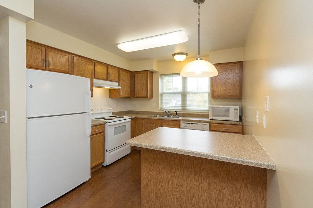 a kitchen with white appliances and a counter top