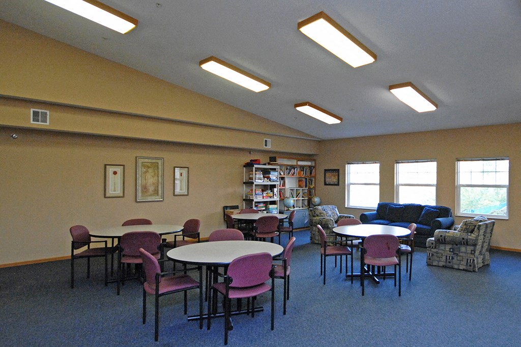 a dining room with tables and chairs and a couch