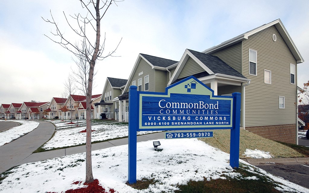 a sign sits in front of a row of houses