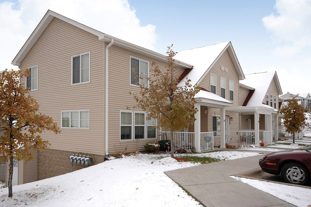 the front of a house with snow on the ground