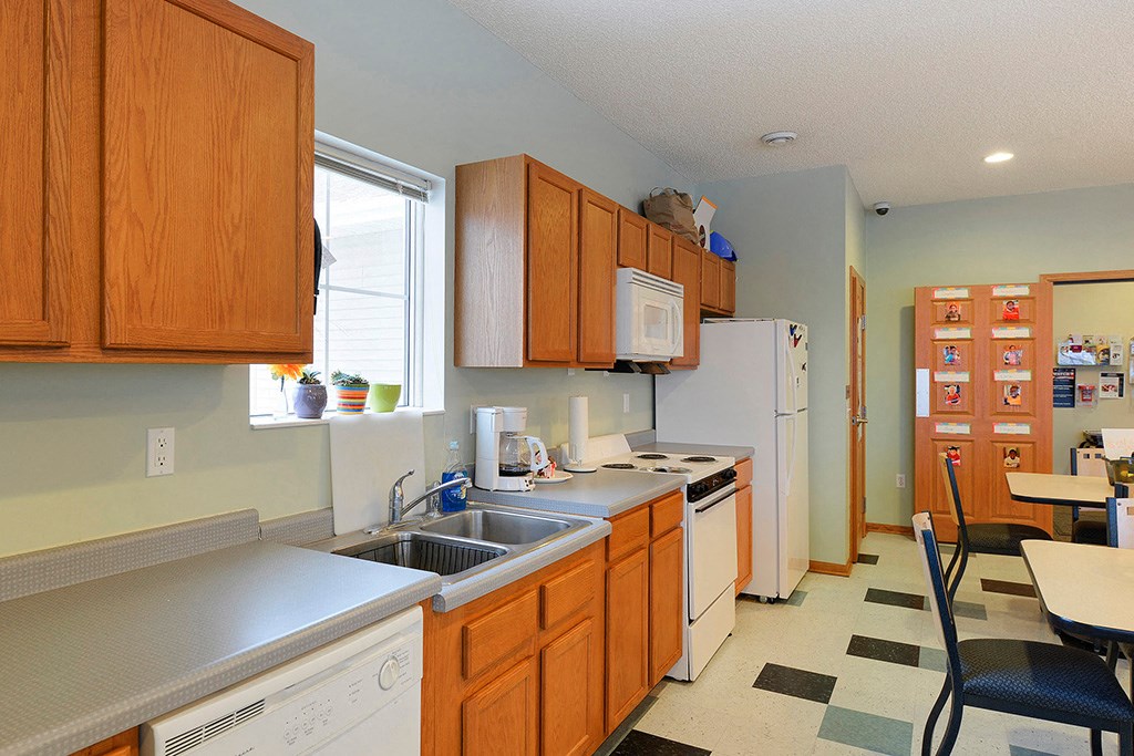 a kitchen with a sink and a refrigerator