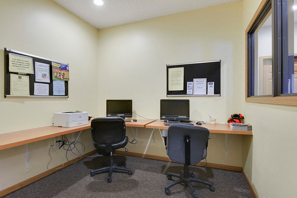 a office with two desks and two computers