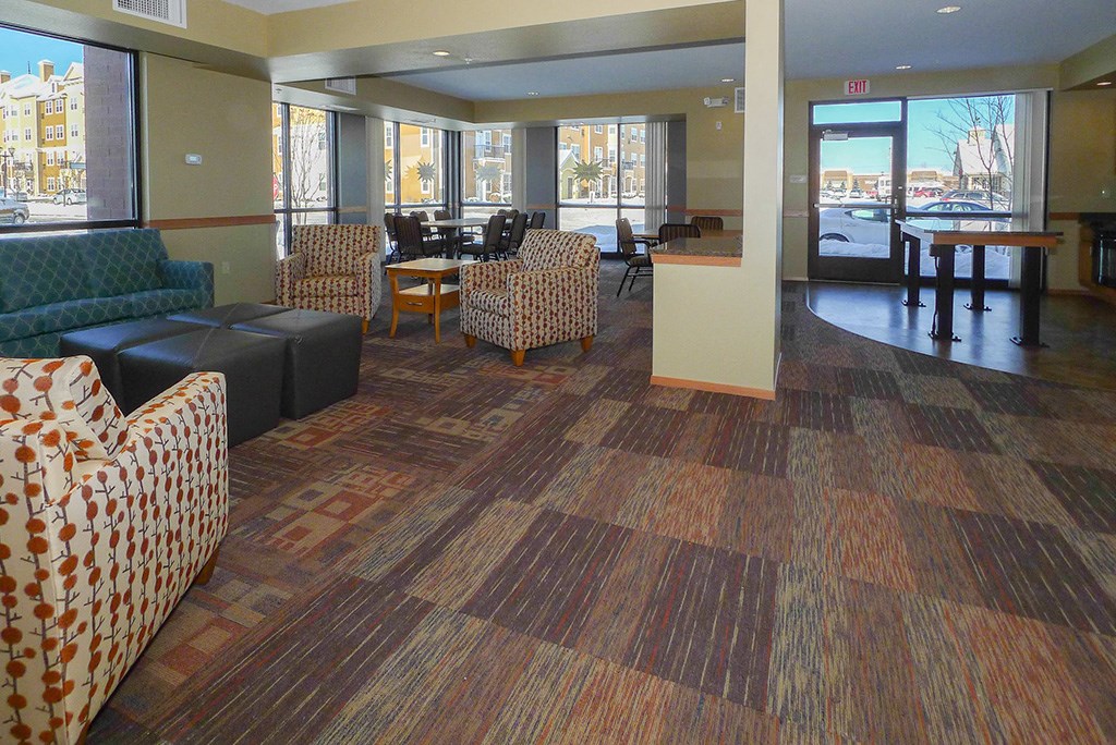 a lobby with couches and chairs and a table