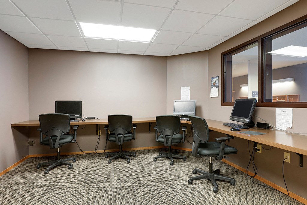 a large room with desks and chairs and computers