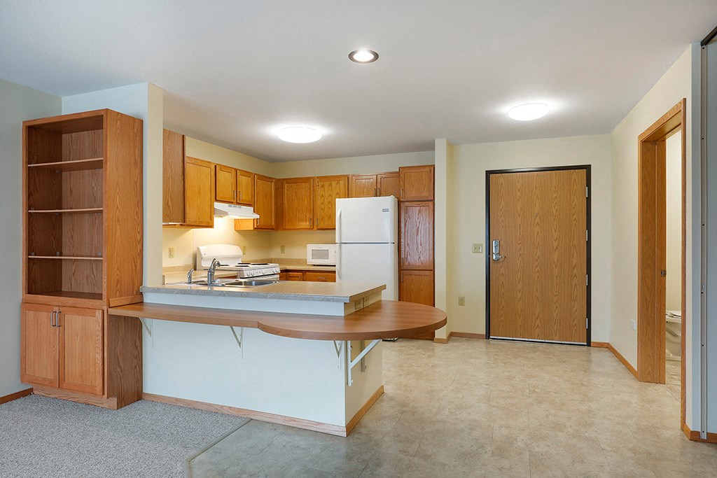 a kitchen with a counter top and a refrigerator