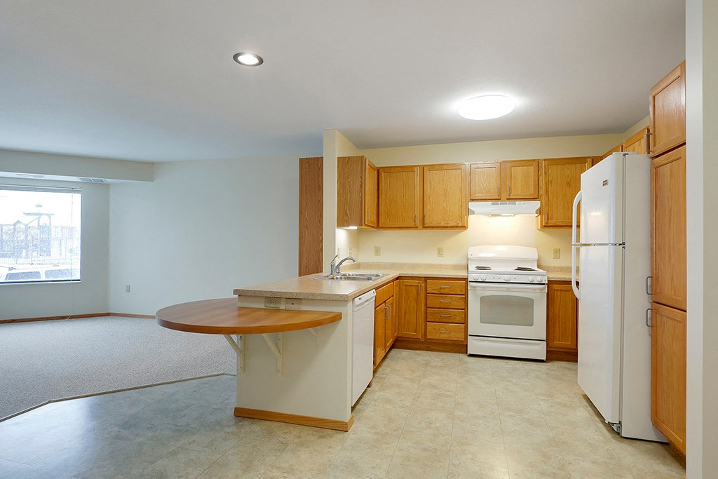 a kitchen with white appliances and wooden cabinets