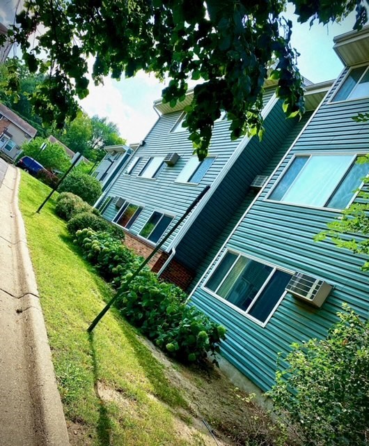 a blue house on the side of a street