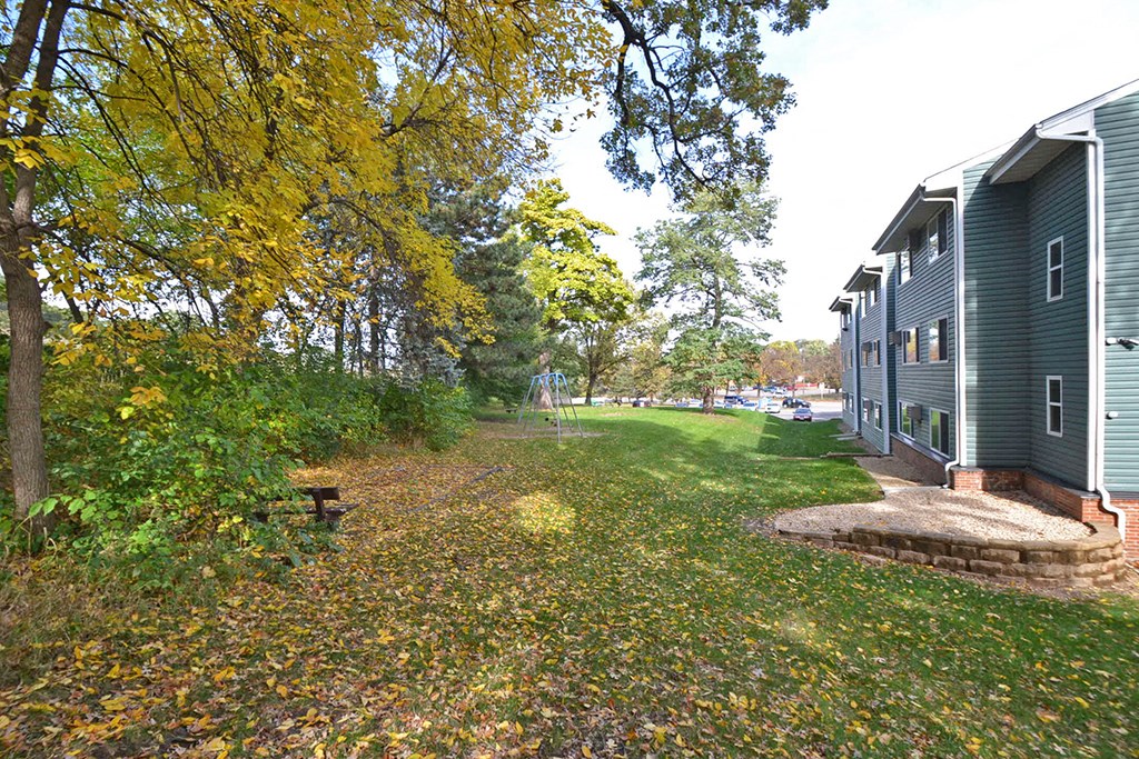 a walkway in front of a house with trees