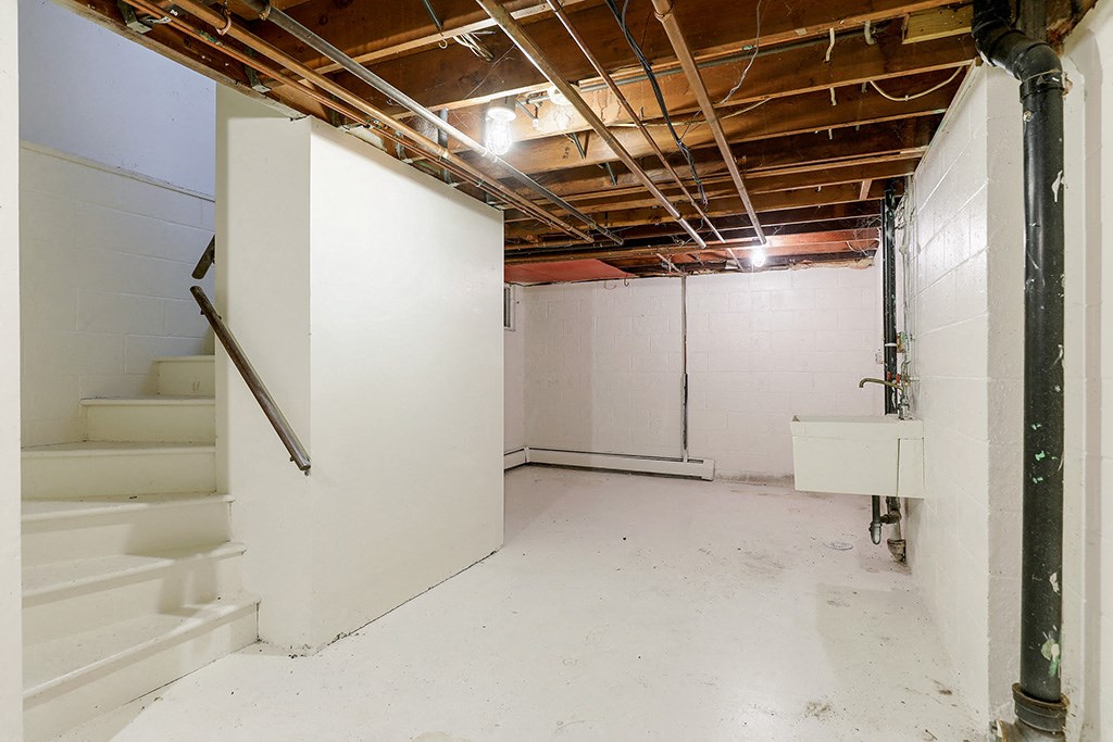 an empty room with white walls and stairs in it