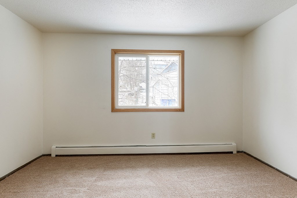 a room with white walls and a window