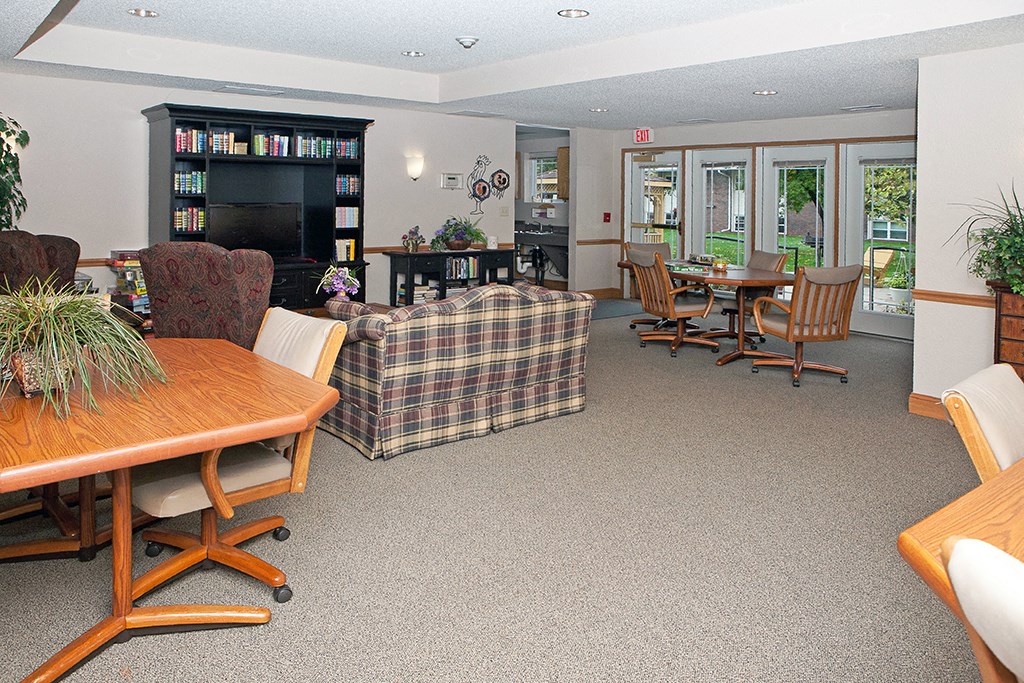 a living room and dining room with a table and chairs