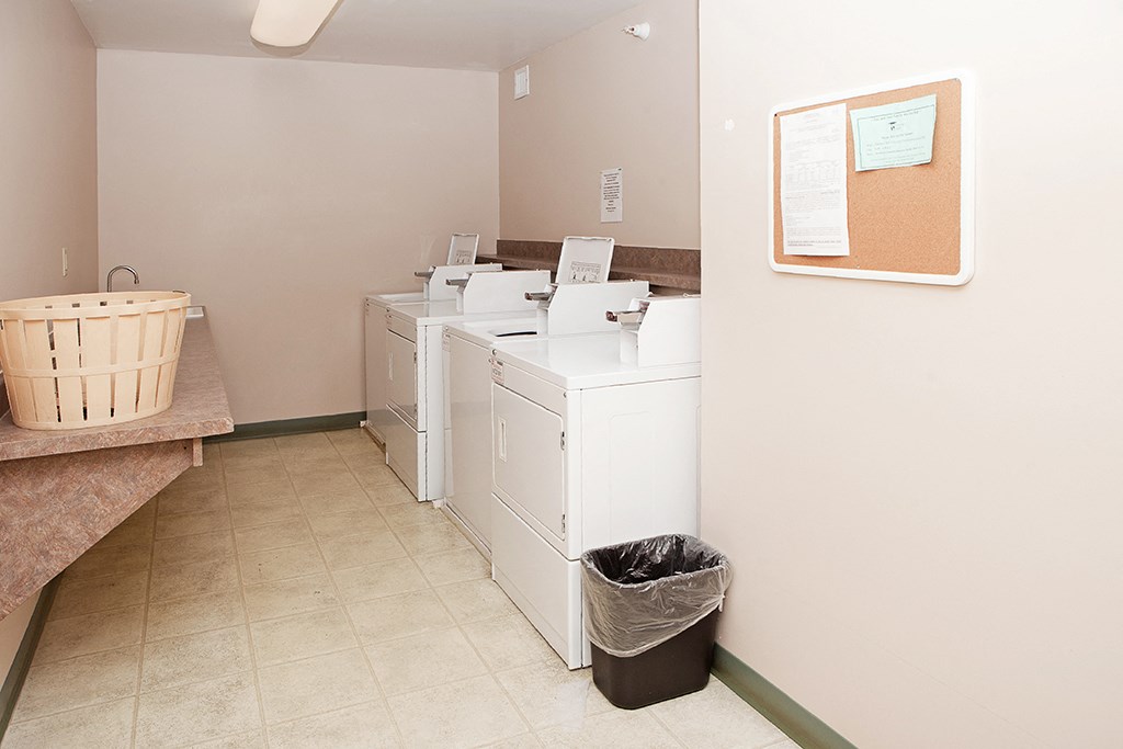 a laundry room with washing machines and a basket