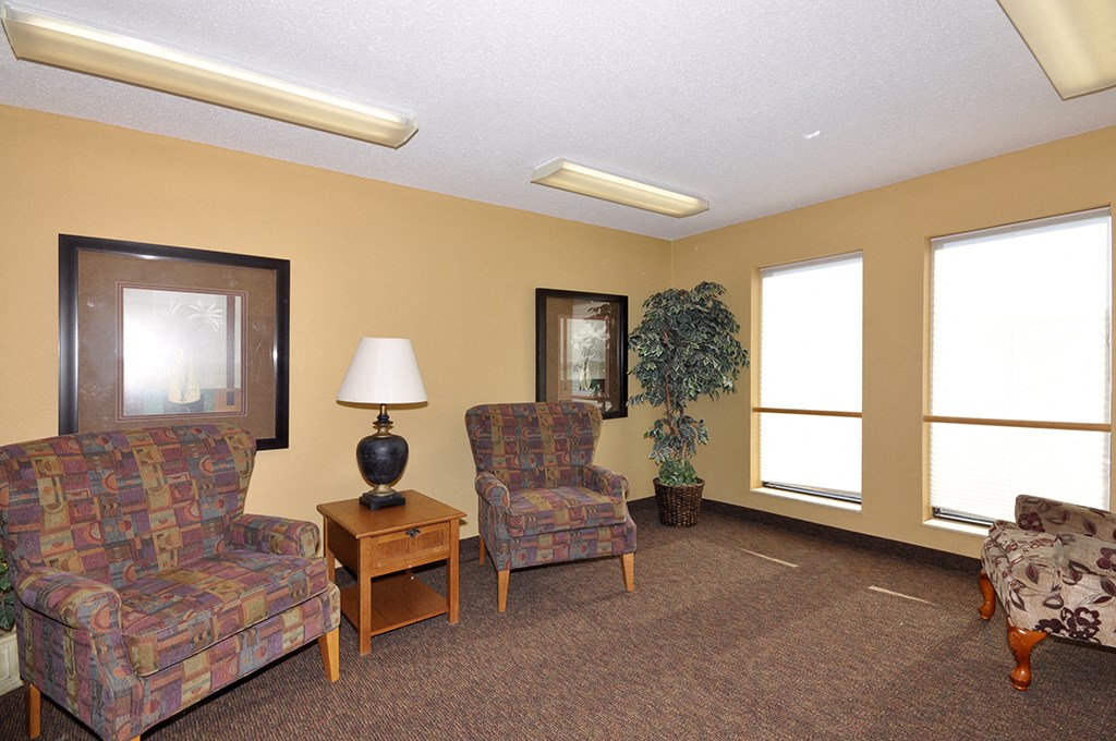 a living room with couches and chairs and a window