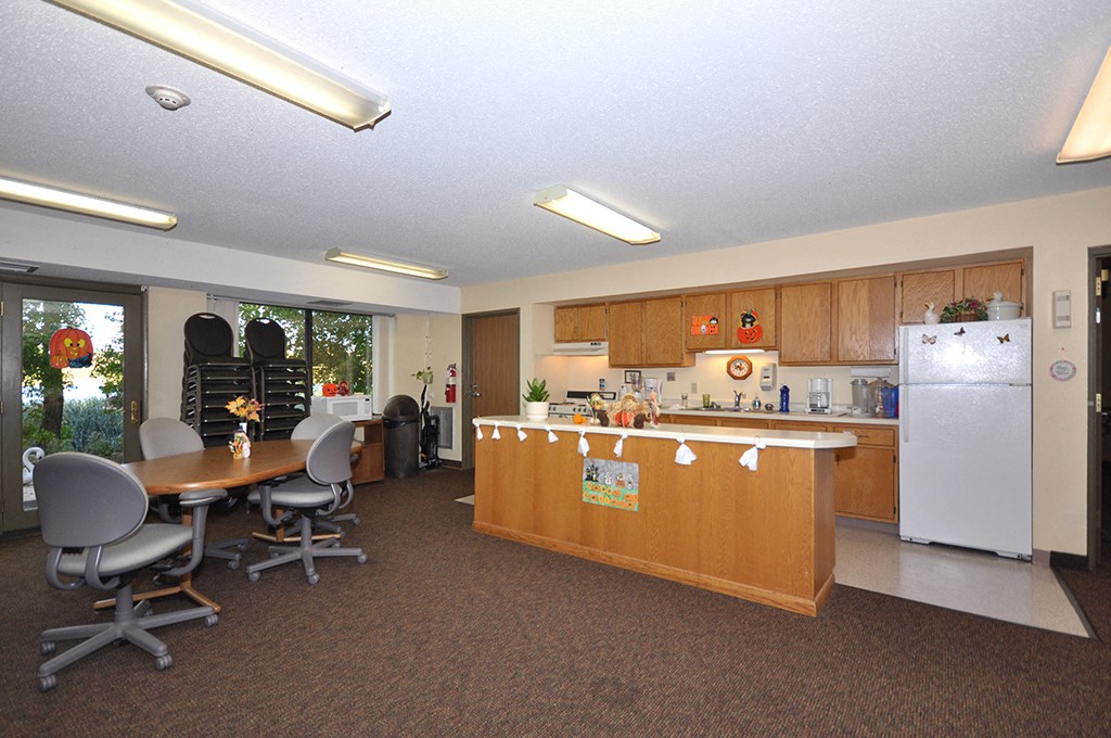 a kitchen and dining room with a table and chairs