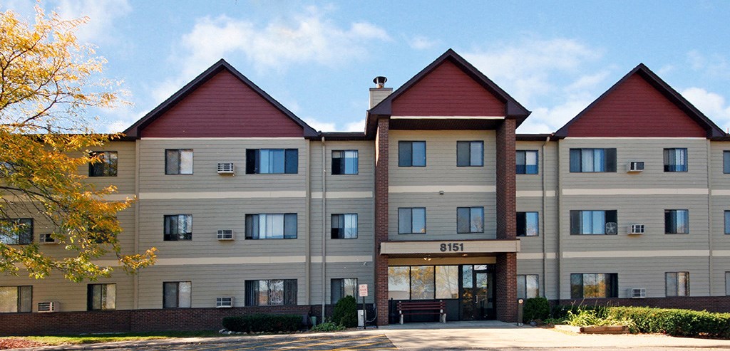 a large apartment building with a parking lot