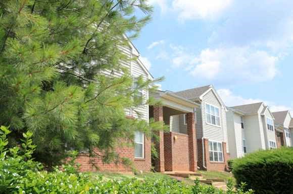 a row of houses with trees in front of them