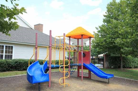 a playground with a swing set and slides