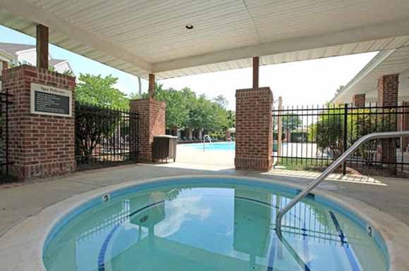 a swimming pool is under a covered porch next to a pool