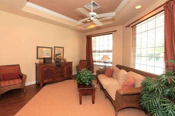 a living room with a couch and a ceiling fan