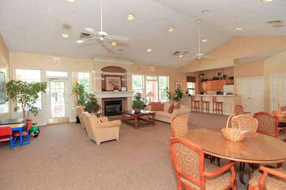 a living room and dining room with a table and chairs