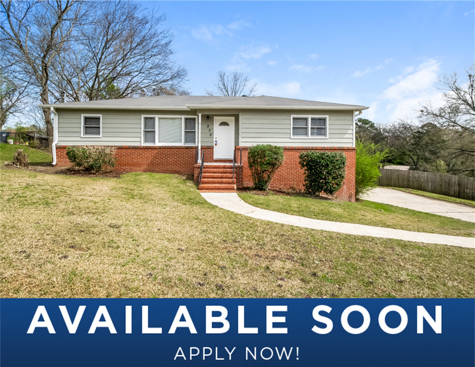 a small house with a lawn and a walkway