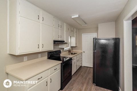 the preserve at ballantyne commons apartment kitchen with black refrigerator and white cabinets