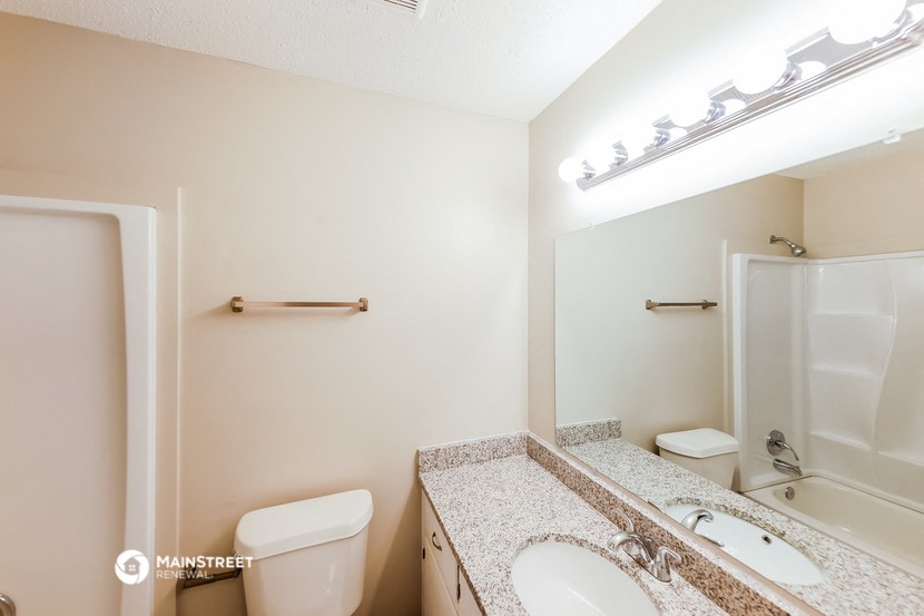 a bathroom with a sink and a toilet and a shower
