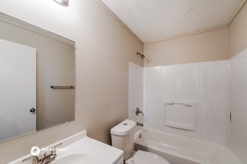 a bathroom with a toilet and a sink and a tub