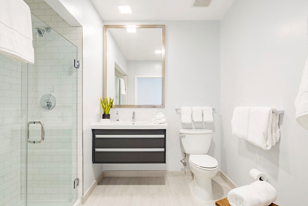 a bathroom with a toilet and a sink and a shower