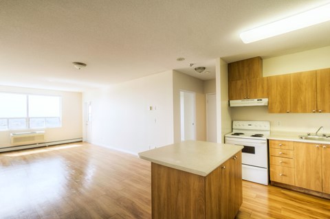 A kitchen with wooden cabinets and a white countertop.