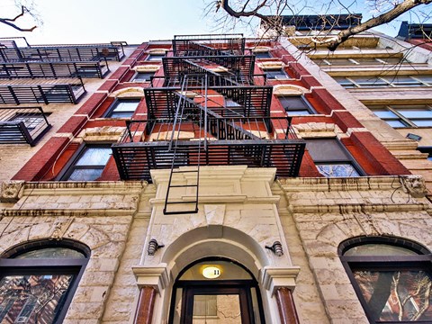 a tall building with a fire escape on the side of it
